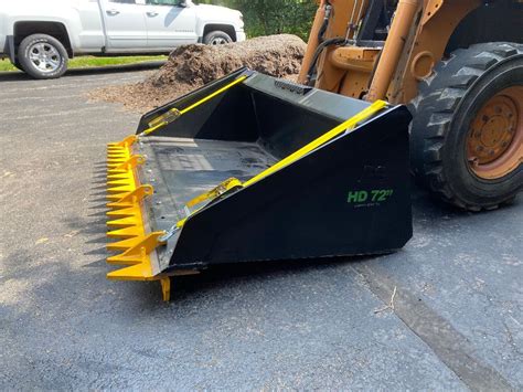 The rake is securely connected to the bucket with a pair of heavy duty ratchet straps that are each rated at a breaking strength of 10,000 pounds. . Ratchet rake